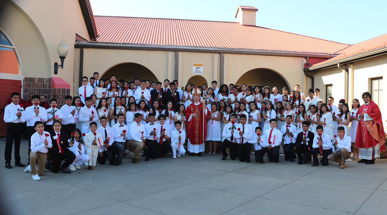 BOONVILLE — Young people at Divine Redeemer Church received the sacrament of confirmation recently from Bishop Peter Jugis. Also pictured with the group is Father Enrique Gonzalez-Gaytan, pastor. (Sergio Lopez | Catholic News Herald)