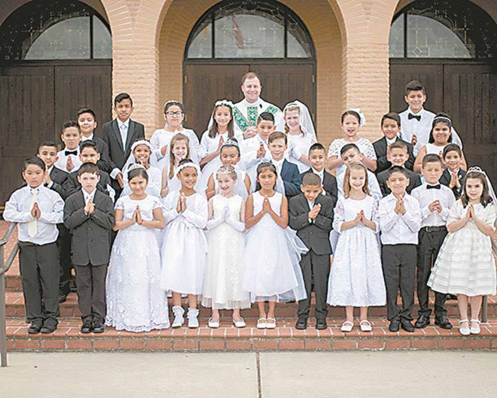 Children at Sacred Heart Church in Salisbury received their first Holy Communion during Mass offered by Father John Eckert, pastor, on May 4. (Bill Washington | Catholic News Herald)