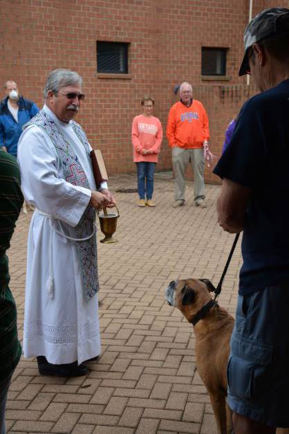 . There were many wagging tails as Father Mark Lawlor learned the names of each of the animals, and they received their blessing. (Provided by Lisa Cash)