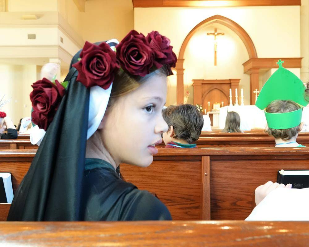 Fr. John Putnam celebrated the Mass and during his homily asked the children to tell him about their saint.