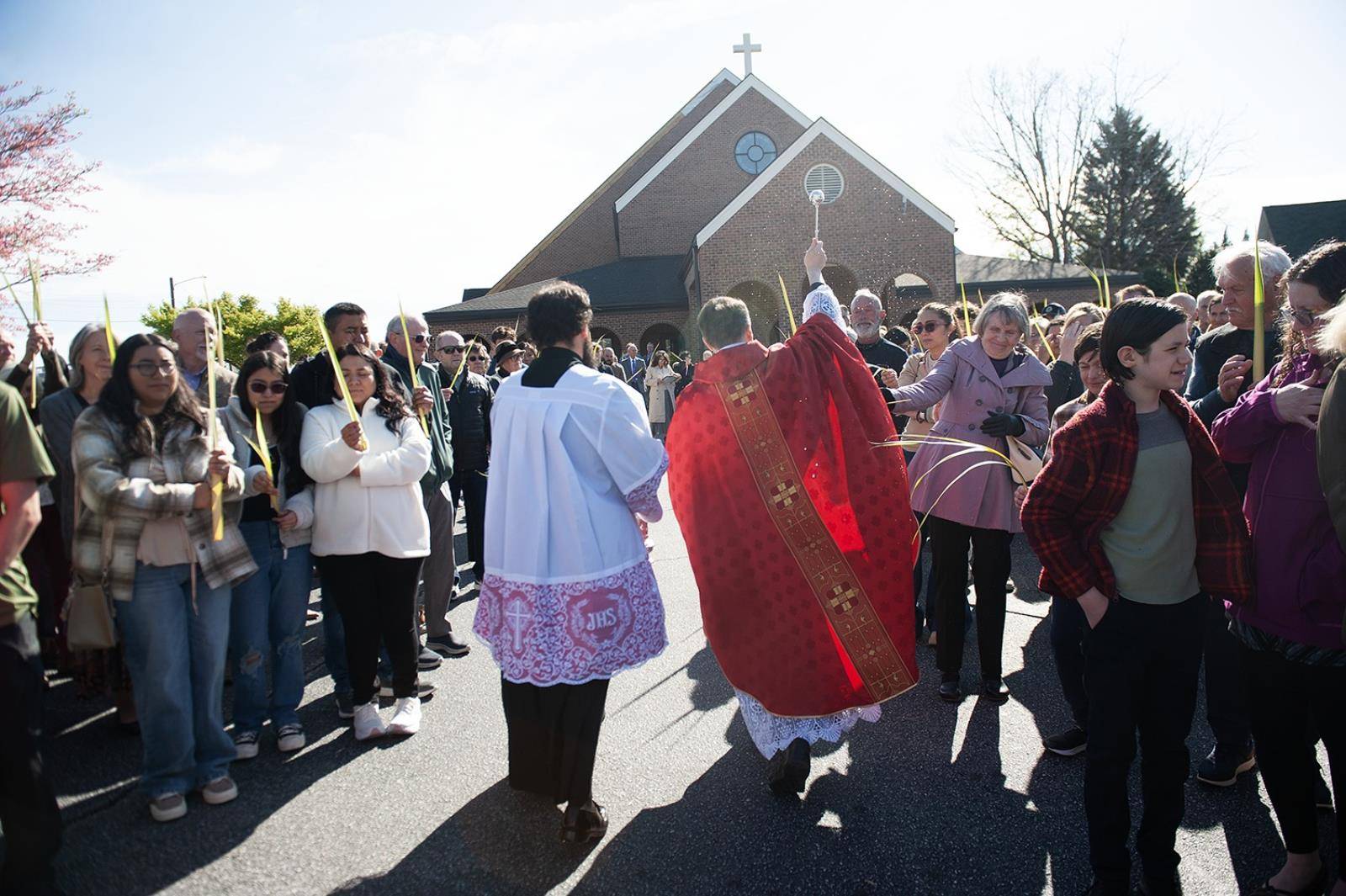 Immaculate Conception Parish in Hendersonville started Holy Week by holding palms in the air as Fathers Andres Felipe Gutierrez and David O'Connor blessed them. (Photos provided)