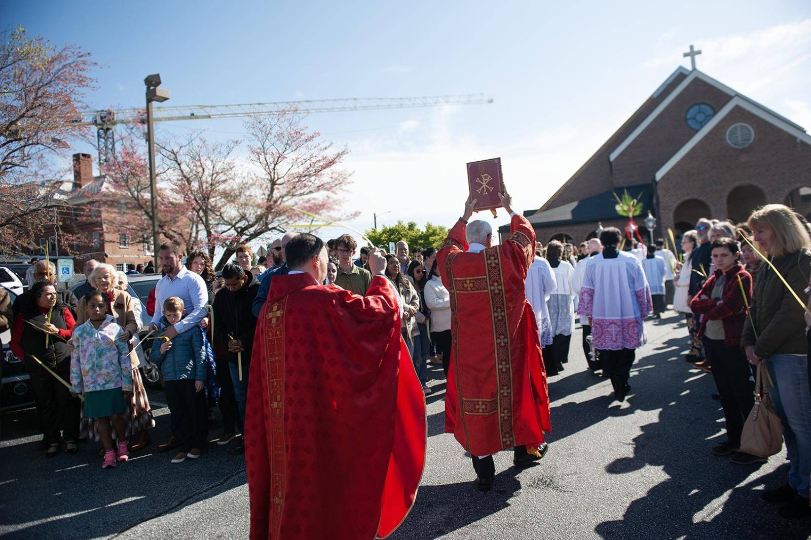 Immaculate Conception Parish in Hendersonville started Holy Week by holding palms in the air as Fathers Andres Felipe Gutierrez and David O'Connor blessed them. (Photos provided)
