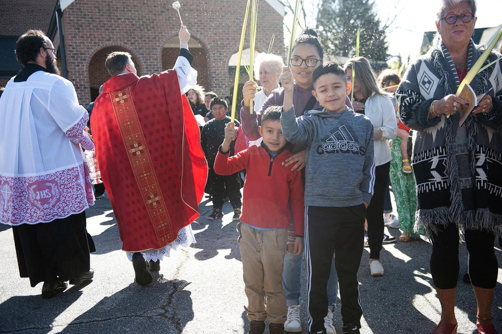 Immaculate Conception Parish in Hendersonville started Holy Week by holding palms in the air as Fathers Andres Felipe Gutierrez and David O'Connor blessed them. (Photos provided)
