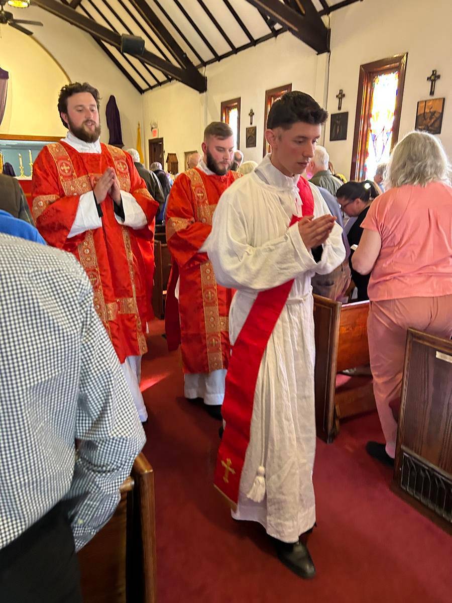 Father Brandon Jones at St. Margaret Mary Church in Swannanoa had help celebrating the Palm Sunday liturgies from three deacons preparing for priestly ordination this June ¬— Deacon Nicholas Kramer, Deacon Andrew Templeton and Deacon Joseph Yellico. (Prov