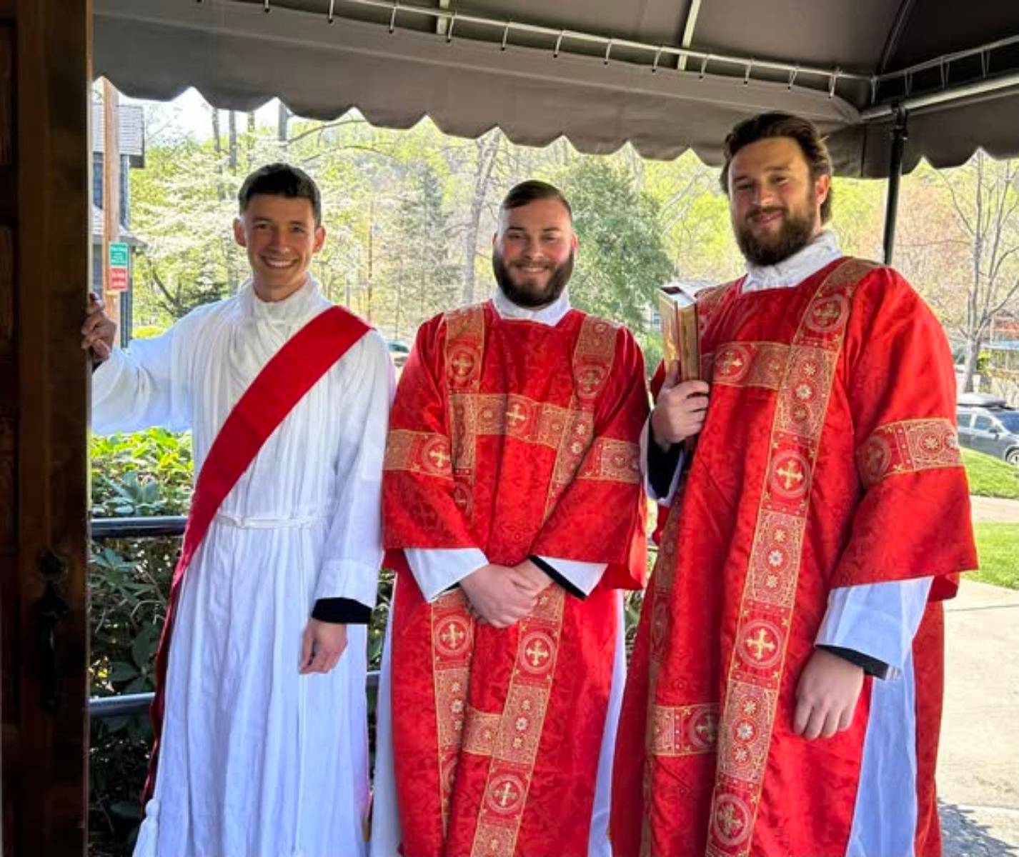 Father Brandon Jones at St. Margaret Mary Church in Swannanoa had help celebrating the Palm Sunday liturgies from three deacons preparing for priestly ordination this June ¬— Deacon Nicholas Kramer, Deacon Andrew Templeton and Deacon Joseph Yellico. (Prov