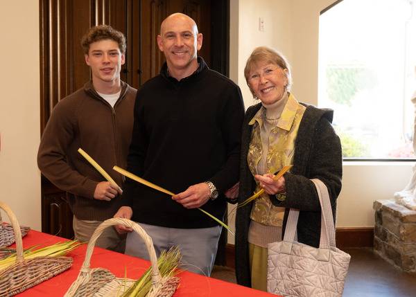 St. Pius X parishioners select palms on their way into Mass. (Mary Ann Luedtke)