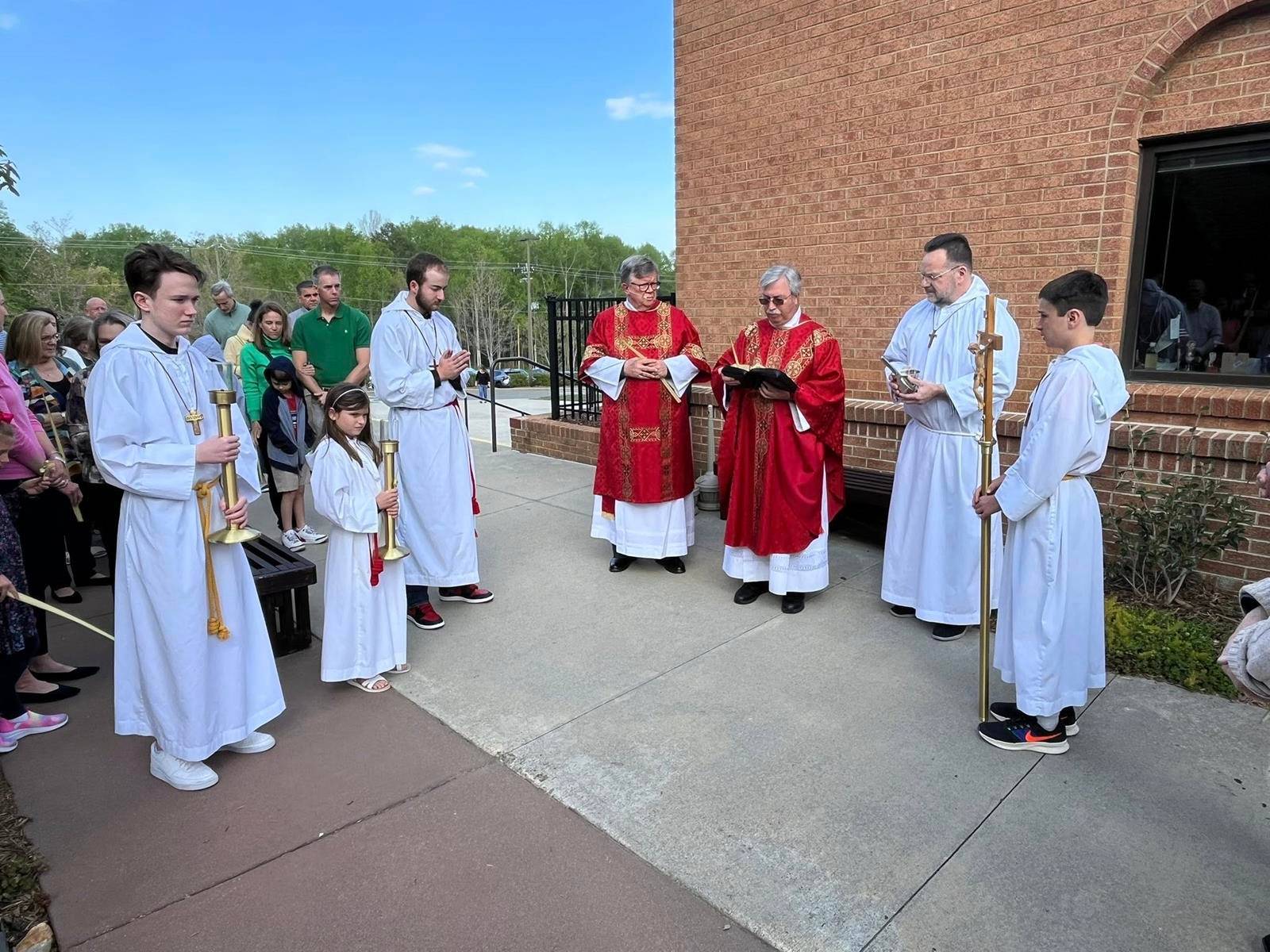Father Mark Lawlor blesses palms outside St. Therese Church in Mooresville. (Provided photo)